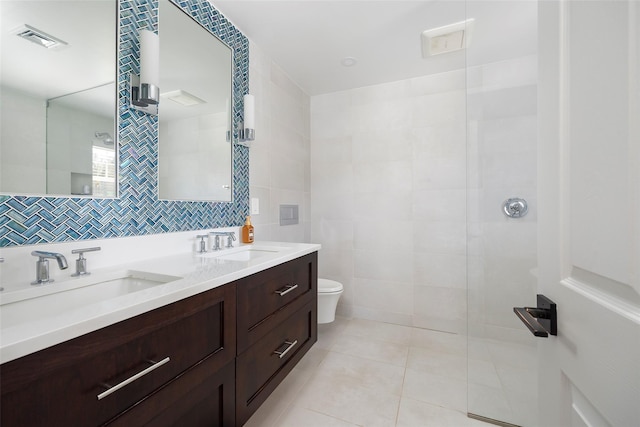 19 Bush Creek Ln, Poughquag, NY 12570 - bathroom featuring toilet, double vanity, tile patterned flooring, tile walls, and a walk in shower