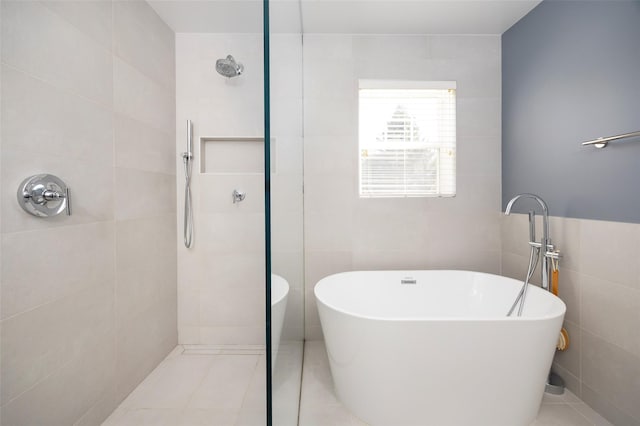 19 Bush Creek Ln, Poughquag, NY 12570 - full bathroom featuring tile walls, a tile shower, a freestanding bath, and tile patterned flooring