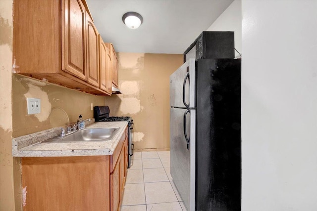 17 Lamartine Ave, Yonkers, NY 10701 - kitchen featuring range with gas cooktop, freestanding refrigerator, light countertops, a sink, and light tile patterned floors