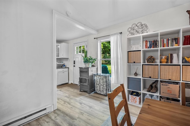 68 Silver Spring Rd, New Windsor, NY 12553 - dining room with a baseboard heating unit and light wood-style flooring