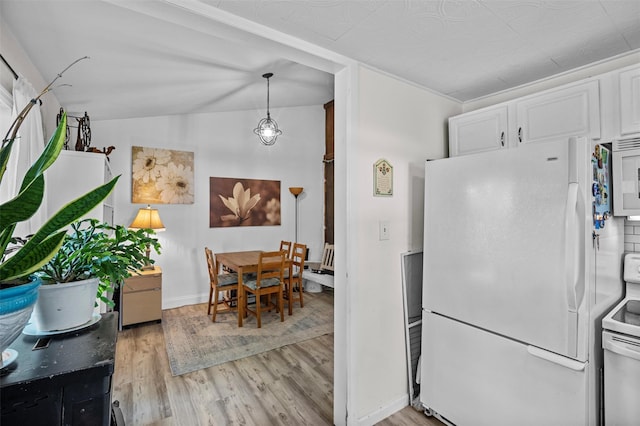 68 Silver Spring Rd, New Windsor, NY 12553 - kitchen featuring white appliances, light wood-style floors, white cabinets, and lofted ceiling