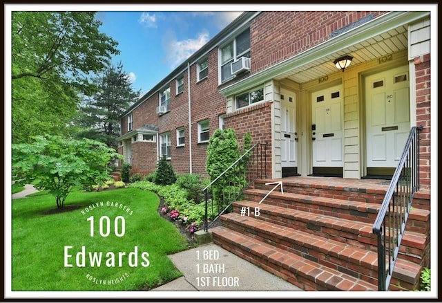 100 Edwards St Unit 1-B, Roslyn Heights, NY 11577 - doorway to property with brick siding, a yard, and cooling unit