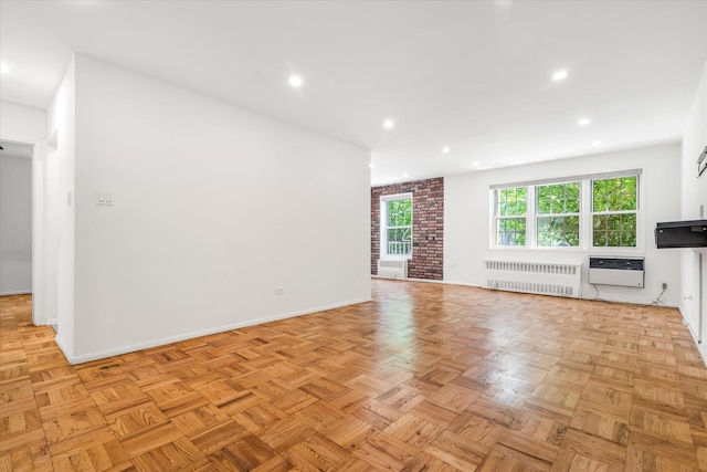 151-15 84th St Unit 1F, Howard Beach, NY 11414 - unfurnished living room featuring radiator, plenty of natural light, baseboards, recessed lighting, and a wall mounted air conditioner