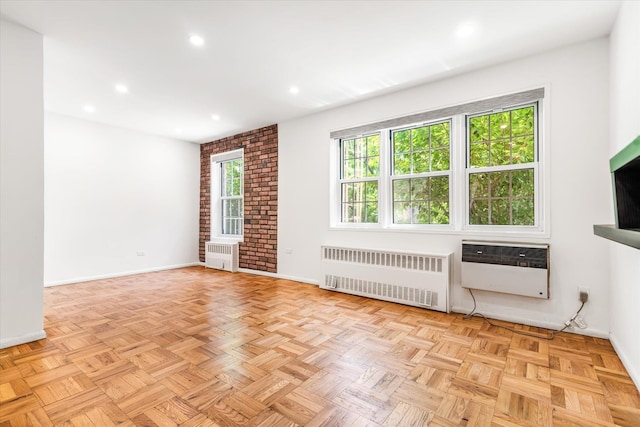 151-15 84th St Unit 1F, Howard Beach, NY 11414 - empty room with radiator heating unit, baseboards, recessed lighting, and a wall mounted air conditioner