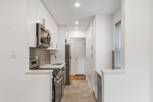 151-15 84th St Unit 1F, Howard Beach, NY 11414 - kitchen featuring stainless steel appliances, a sink, backsplash, white cabinetry, and recessed lighting