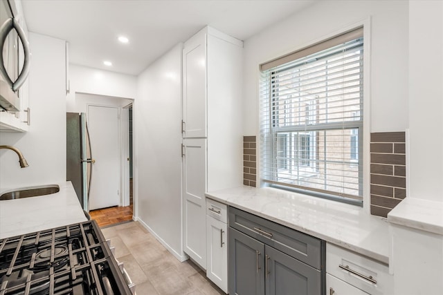 151-15 84th St Unit 1F, Howard Beach, NY 11414 - kitchen featuring a sink, appliances with stainless steel finishes, tasteful backsplash, light stone countertops, and recessed lighting