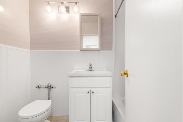 151-15 84th St Unit 1F, Howard Beach, NY 11414 - full bathroom featuring vanity, toilet, a tub, and a wainscoted wall
