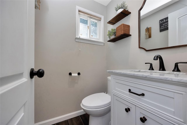 2985 Cheryl Rd, Merrick, NY 11566 - bathroom featuring toilet, vanity, wood finished floors, and baseboards