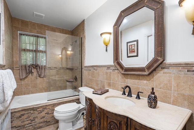 18 Birchwood Park Dr, Syosset, NY 11791 - full bathroom featuring tile walls, vanity, tiled shower / bath combo, toilet, and wainscoting