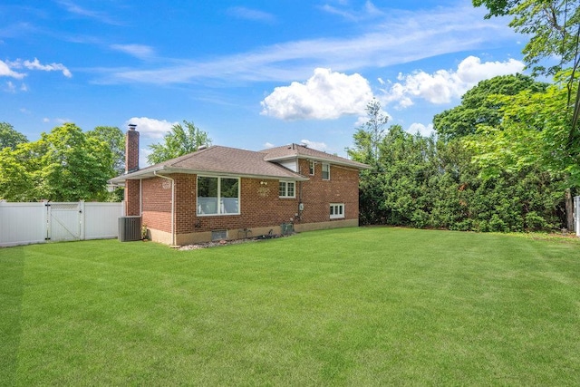 18 Birchwood Park Dr, Syosset, NY 11791 - rear view of property with a gate, a chimney, central AC unit, brick siding, and a shingled roof