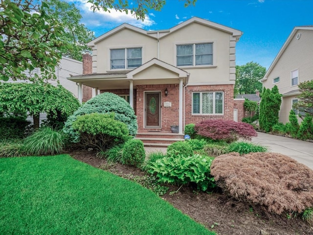18 Ashland Ave, New Hyde Park, NY 11040 - traditional-style home featuring brick siding and stucco siding