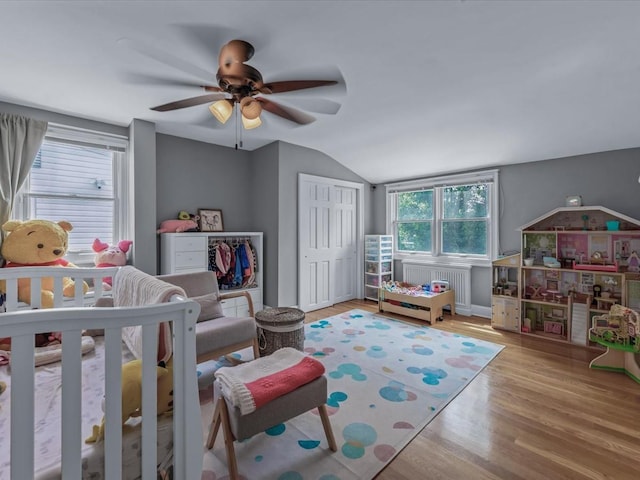 18 Ashland Ave, New Hyde Park, NY 11040 - bedroom with lofted ceiling, wood finished floors, a closet, ceiling fan, and radiator