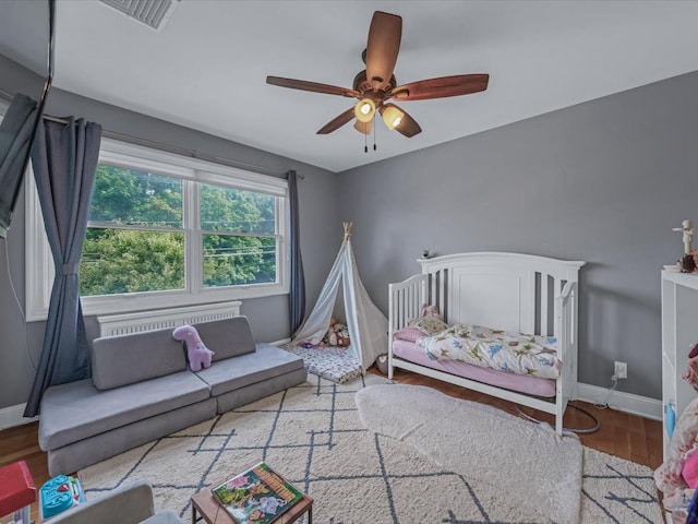 18 Ashland Ave, New Hyde Park, NY 11040 - bedroom featuring baseboards, wood finished floors, and a ceiling fan