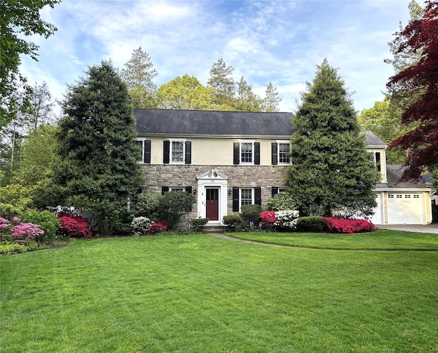20 Hemlock Dr, Sleepy Hollow, NY 10591 - colonial home with stone siding, a front yard, a garage, and driveway