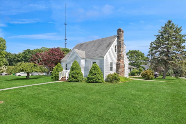1295 Washington Ave, Greenport, NY 11944 - view of side of property featuring a chimney, a lawn, and roof with shingles