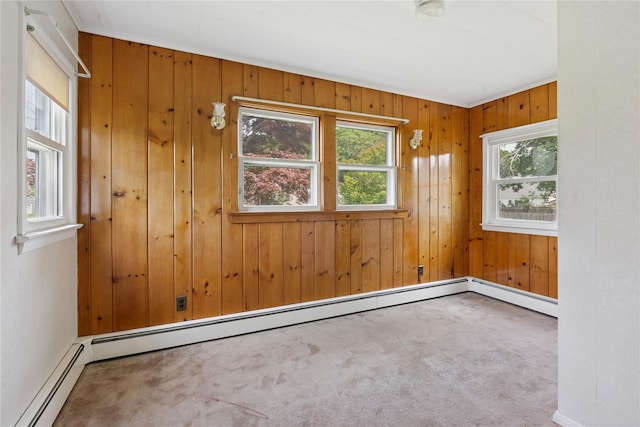 1295 Washington Ave, Greenport, NY 11944 - unfurnished room featuring carpet floors, wooden walls, and baseboard heating
