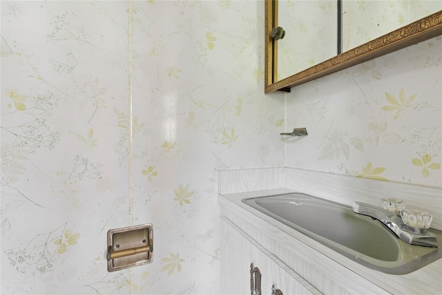 1295 Washington Ave, Greenport, NY 11944 - bathroom featuring wallpapered walls and vanity