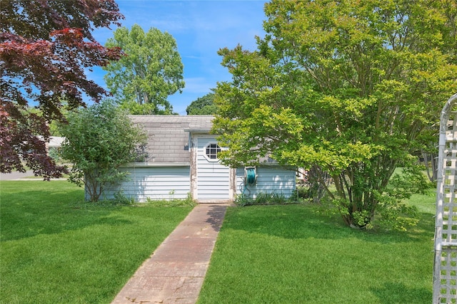 1295 Washington Ave, Greenport, NY 11944 - obstructed view of property with roof with shingles, a front lawn, and an outbuilding