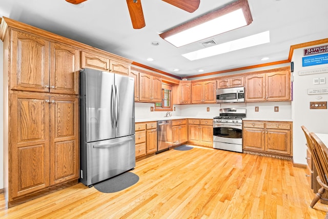 2A Suffern Ln, Garnerville, NY 10923 - kitchen with appliances with stainless steel finishes, a skylight, light wood-style floors, light countertops, and recessed lighting