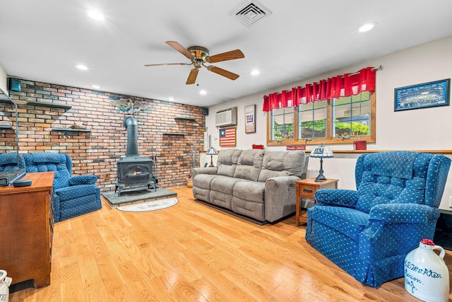 2A Suffern Ln, Garnerville, NY 10923 - living area with a wood stove, a ceiling fan, brick wall, wood finished floors, and recessed lighting