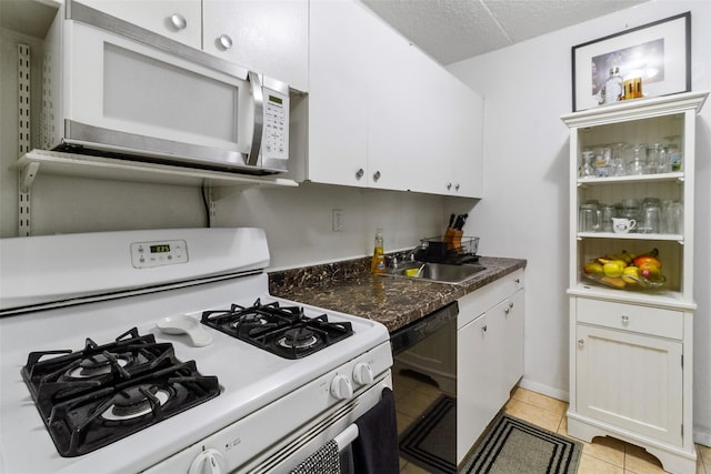 200 Diplomat Dr Unit 3D, Mount Kisco, NY 10549 - kitchen with white appliances, a sink, white cabinetry, and light tile patterned floors
