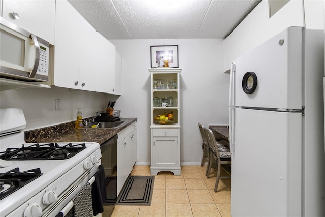 200 Diplomat Dr Unit 3D, Mount Kisco, NY 10549 - kitchen with white appliances, white cabinetry, a sink, a textured ceiling, and light tile patterned floors