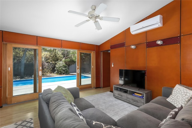 521 Fire Island Blvd, Fire Island Pines, NY 11782 - living area featuring an AC wall unit, vaulted ceiling, light wood finished floors, and a ceiling fan