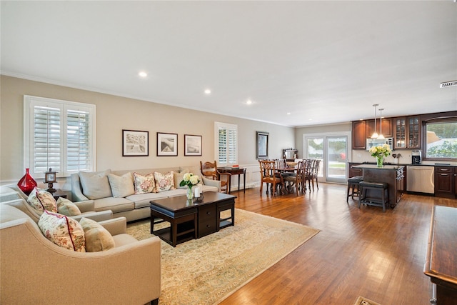 4 Valley Rd, Syosset, NY 11791 - living area with wood finished floors, ornamental molding, and recessed lighting