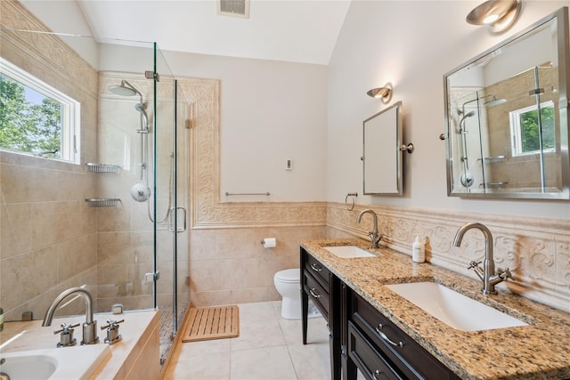 4 Valley Rd, Syosset, NY 11791 - bathroom featuring tile walls, double vanity, a shower stall, a bath, and tile patterned floors