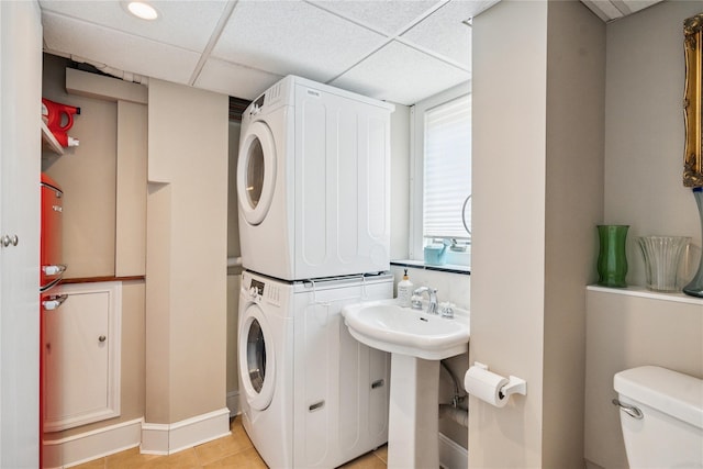 4 Valley Rd, Syosset, NY 11791 - laundry room with estacked washer and dryer and light tile patterned flooring