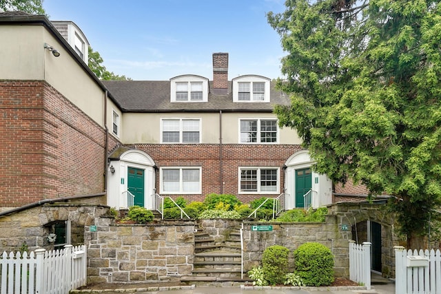11 Sentry Pl Unit 2C, Scarsdale, NY 10583 - townhome / multi-family property featuring stucco siding, a chimney, roof with shingles, and brick siding