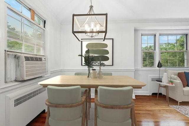 11 Sentry Pl Unit 2C, Scarsdale, NY 10583 - dining room with radiator, crown molding, a chandelier, and wood finished floors