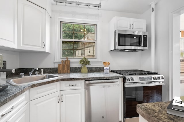 11 Sentry Pl Unit 2C, Scarsdale, NY 10583 - kitchen with appliances with stainless steel finishes, white cabinets, dark countertops, and wood finished floors