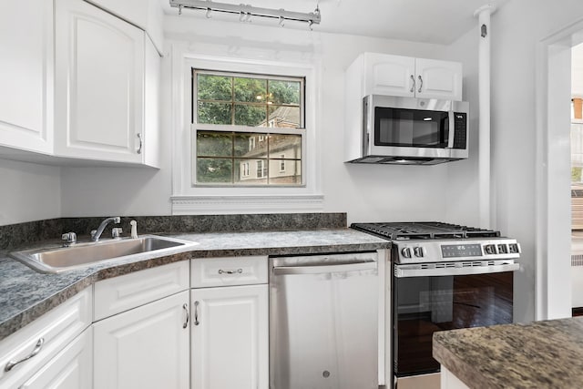 11 Sentry Pl Unit 2C, Scarsdale, NY 10583 - kitchen with appliances with stainless steel finishes, dark countertops, white cabinets, and wood finished floors