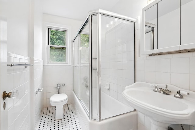 11 Sentry Pl Unit 2C, Scarsdale, NY 10583 - bathroom featuring tile walls, combined bath / shower with glass door, and tile patterned flooring