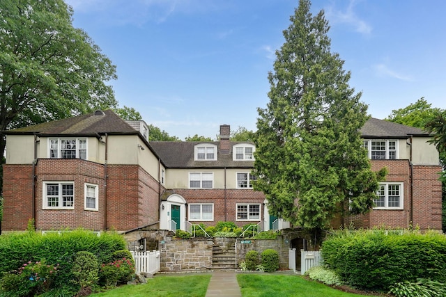 11 Sentry Pl Unit 2C, Scarsdale, NY 10583 - view of front facade featuring stucco siding, a chimney, brick siding, and stairs
