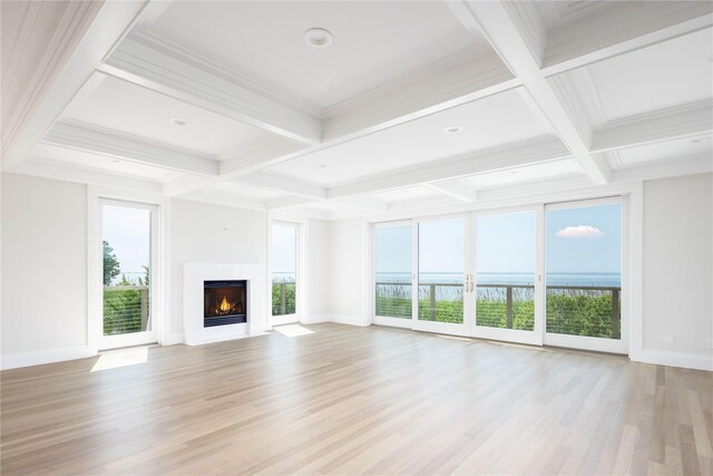 7 Convent Ln, Center Moriches, NY 11934 - unfurnished living room featuring coffered ceiling, healthy amount of natural light, beam ceiling, light wood-style flooring, and a lit fireplace