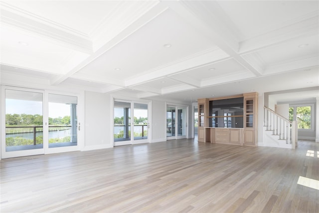 7 Convent Ln, Center Moriches, NY 11934 - unfurnished living room featuring coffered ceiling, beamed ceiling, light wood finished floors, crown molding, and a water view