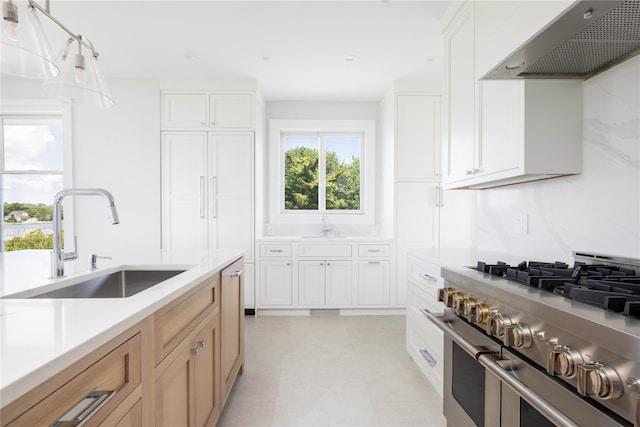 7 Convent Ln, Center Moriches, NY 11934 - kitchen with high end range, wall chimney exhaust hood, light countertops, white cabinets, and hanging light fixtures