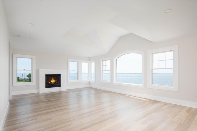 7 Convent Ln, Center Moriches, NY 11934 - unfurnished living room featuring light wood-type flooring, plenty of natural light, and vaulted ceiling