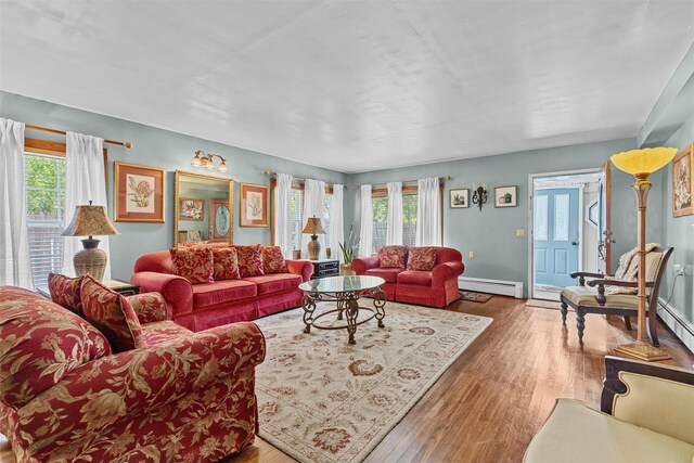 484 Rte 211 W, Middletown, NY 10940 - living room with a baseboard heating unit, healthy amount of natural light, and wood finished floors