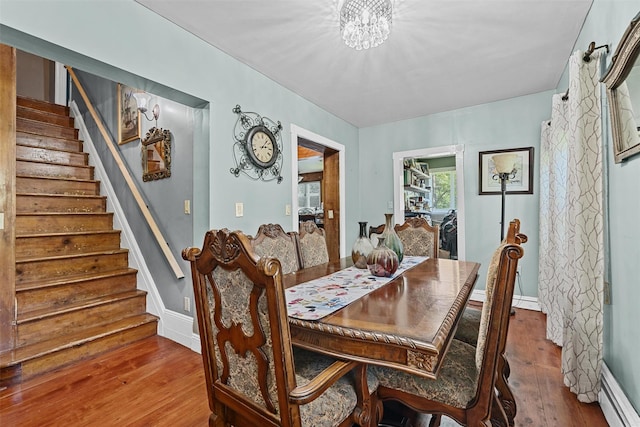 484 Rte 211 W, Middletown, NY 10940 - dining space featuring wood-type flooring, baseboard heating, stairway, and baseboards