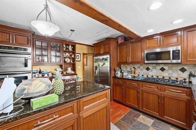 484 Rte 211 W, Middletown, NY 10940 - kitchen featuring appliances with stainless steel finishes, decorative backsplash, dark stone countertops, glass insert cabinets, and recessed lighting