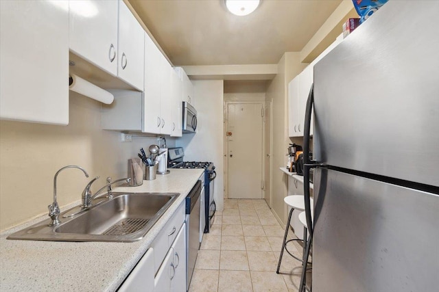 3 Fordham Hill Oval Unit 10B, Bronx, NY 10468 - kitchen featuring appliances with stainless steel finishes, a sink, white cabinetry, light countertops, and light tile patterned flooring
