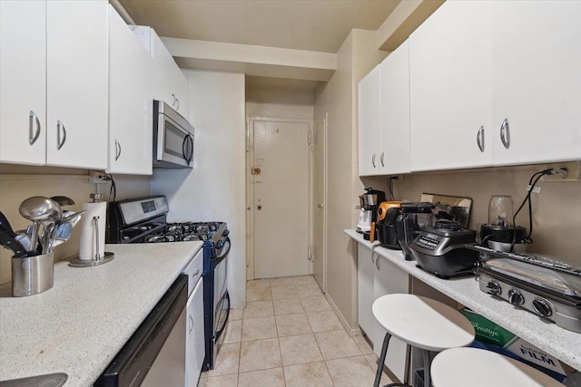 3 Fordham Hill Oval Unit 10B, Bronx, NY 10468 - kitchen with stainless steel appliances, white cabinetry, and light tile patterned floors