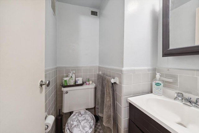 3 Fordham Hill Oval Unit 10B, Bronx, NY 10468 - half bath with vanity, tile walls, toilet, and a wainscoted wall
