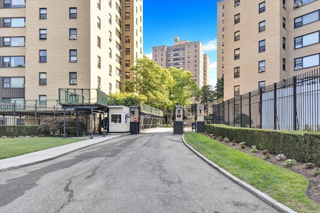 3 Fordham Hill Oval Unit 10B, Bronx, NY 10468 - view of asphalt road featuring curbs, a gated entry, and sidewalks
