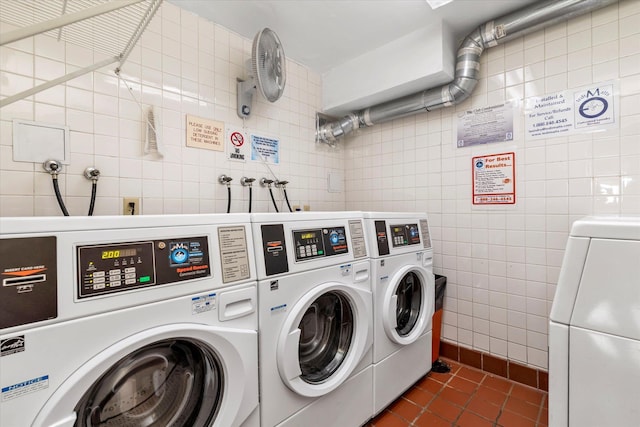 2 Bay Club Dr Unit 2B, Bayside, NY 11360 - community laundry room with washer and clothes dryer, tile walls, and dark tile patterned floors