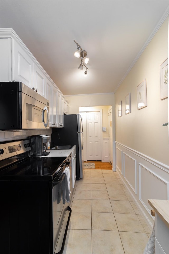 2449 Union Blvd Unit 36-A, Islip, NY 11751 - kitchen featuring range with electric stovetop, stainless steel microwave, white cabinetry, light tile patterned floors, and a sink