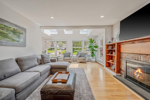 85 Fairmount St, Huntington, NY 11743 - living room featuring a skylight, a fireplace, light wood-style flooring, and recessed lighting